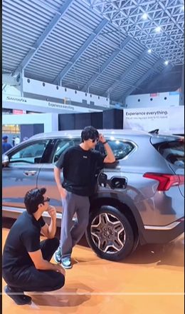 Creator posing beside the Santa Fe Hybrid at the launch venue